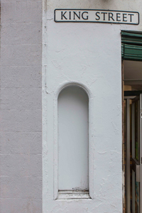 Arched niche on the exterior of 47 King Street formerly used to house the "railway time" clock